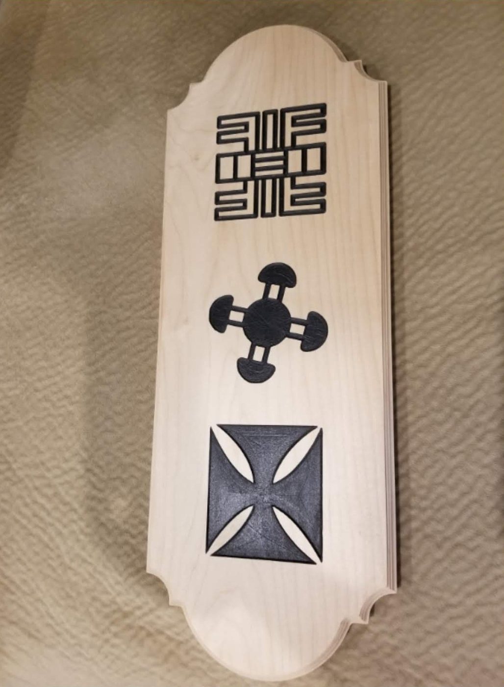 Three symbols on a maple plaque